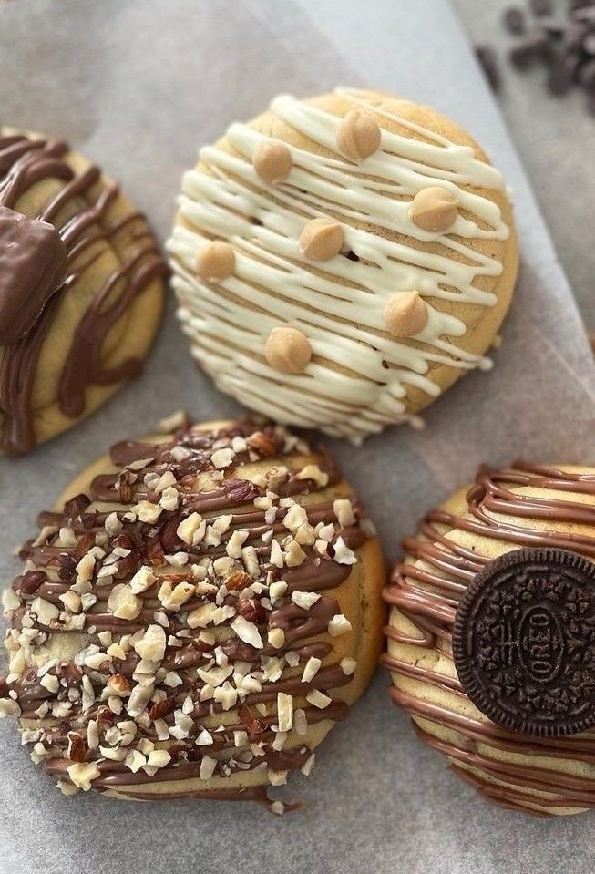 Decorated chunky cookies with chocolate drizzle and toppings.